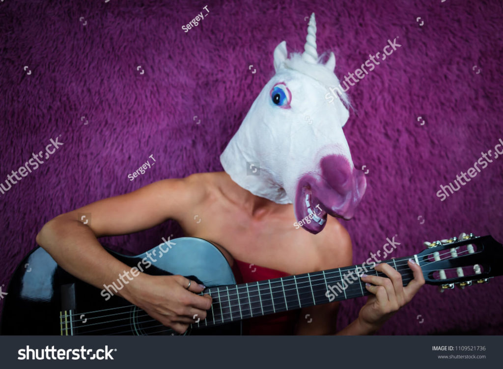 stock-photo-weird-young-woman-in-comical-mask-playing-the-guitar